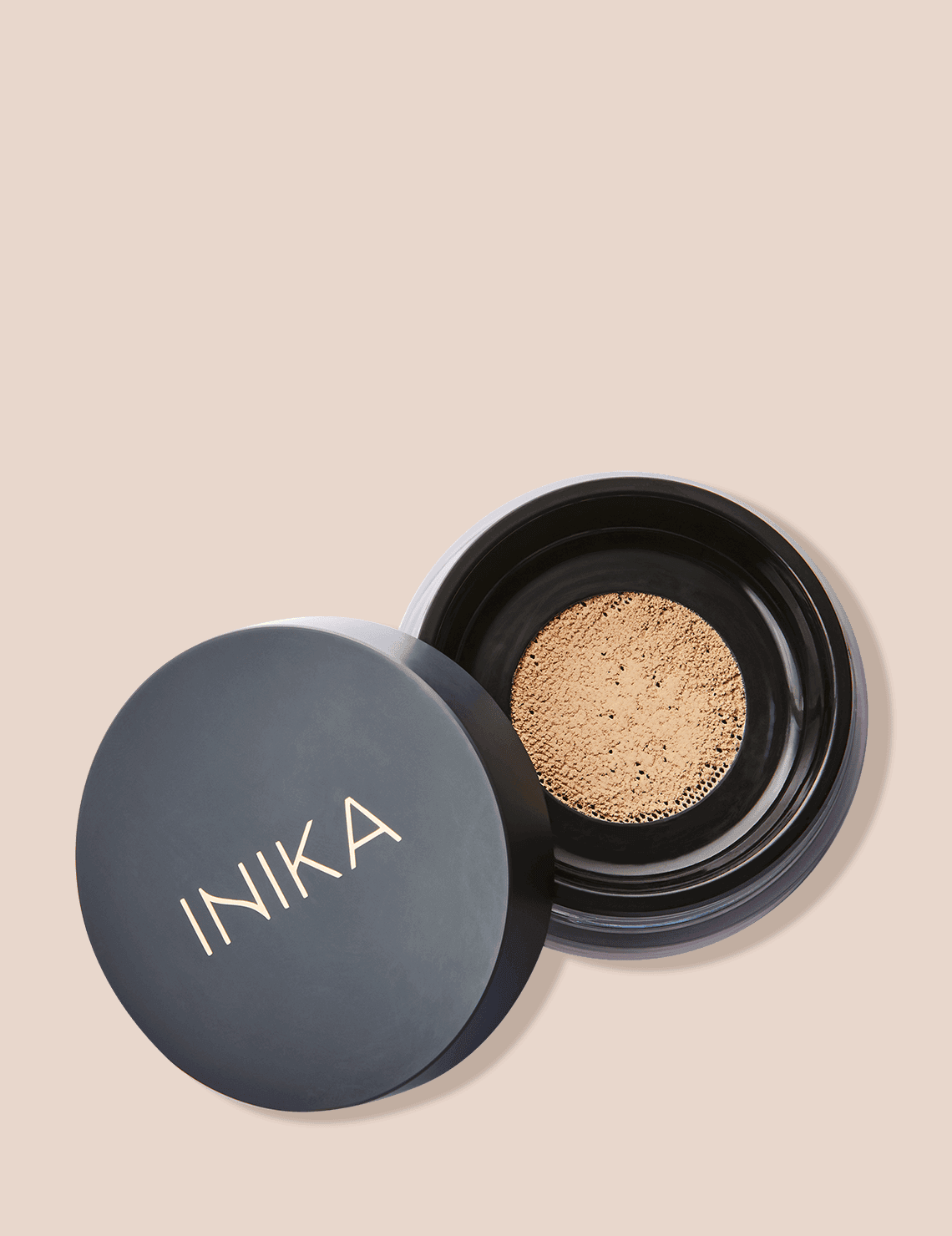 INIKA Organic Loose Mineral Foundation in Unity, shown as loose powder in an open jar